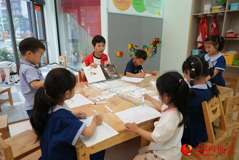 “共享奶奶”周玲珍正在為孩子們講繪本。人民網(wǎng) 陳陸洵攝